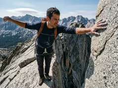 Stuck on Exposed Rock? Here Is When to Turn Back Hiker paused on exposed granite ridge evaluating when to turn back on a scramble