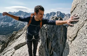 Stuck on Exposed Rock? Here Is When to Turn Back Hiker paused on exposed granite ridge evaluating when to turn back on a scramble