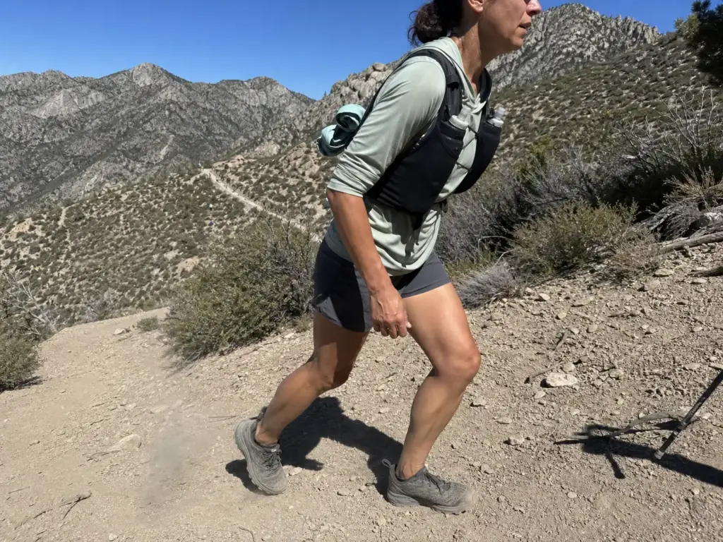 Fast hiker climbing a switchback with a light vest, showing weight on feet