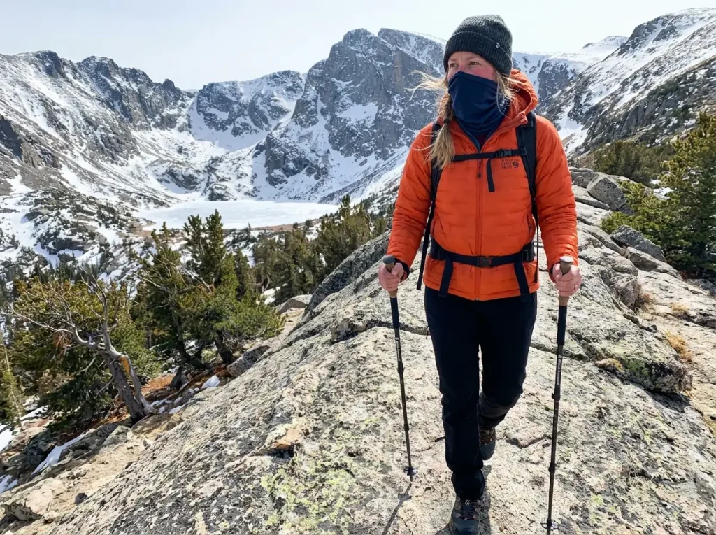 Hiker wearing Buff over mouth while hiking an exposed alpine ridge in cold conditions