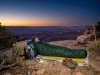 After 200 Nights Out This Is When I Skip the Tent Hiker sleeping in a sleeping bag under open stars on a desert ridge at dusk