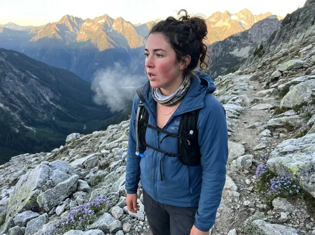 Hiker breathing visible vapor on a cold high altitude morning above treeline