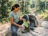 Do Orthotics in Hiking Boots Help? A Hiker’s Verdict Hiker inserting orthotic insole into hiking boot on a rocky trail