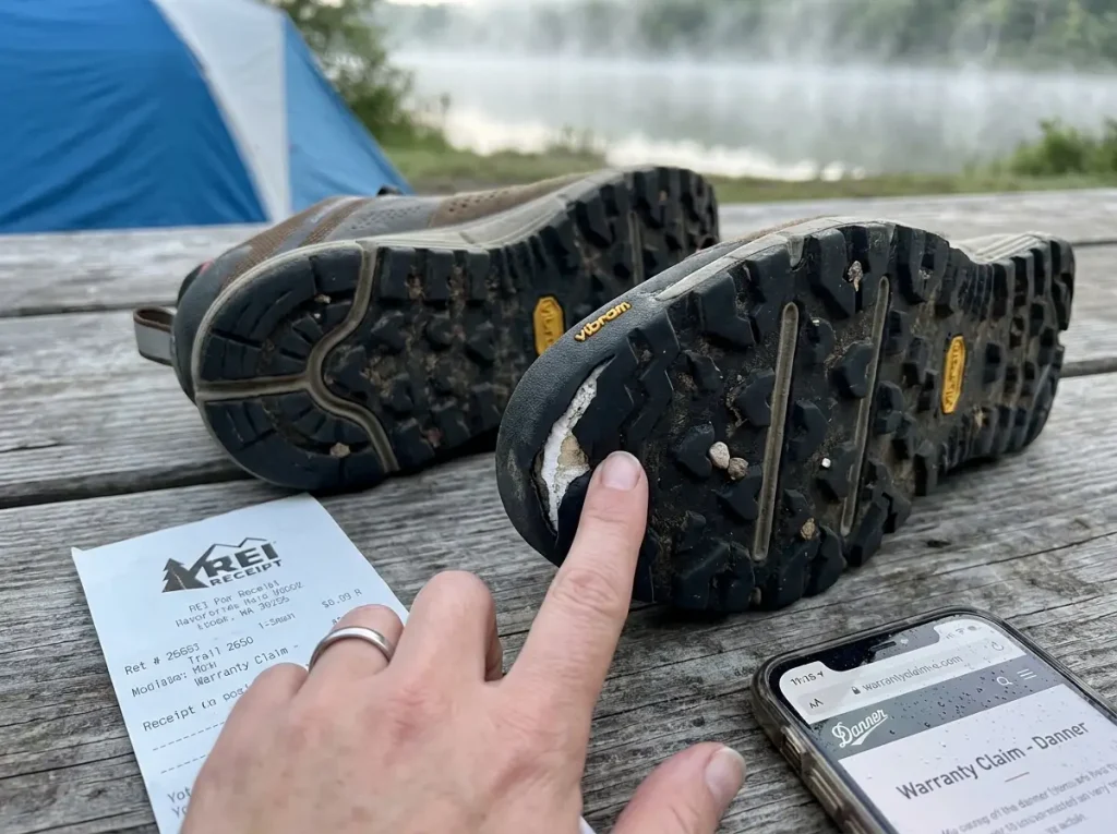 Close-up of a hiking boot sole showing delaminated rubber at the toe