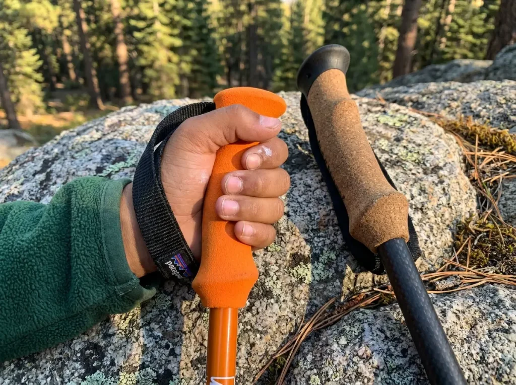 Close-up of child's hand gripping a kids-sized trekking pole foam handle