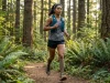 Trail Running for Hikers Without Wrecking Your Knees Trail runner on single track trail through mountain forest at sunrise