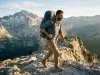 Backpacking Backpacks Buying Guide Fit Beats Specs Hiker on a granite ridge under a loaded multi-day backpacking backpack at golden hour