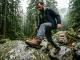 7 Men’s Leather Hiking Boots Tested One Clear Winner Man in full-grain leather hiking boots navigating rocky trail in Pacific Northwest forest