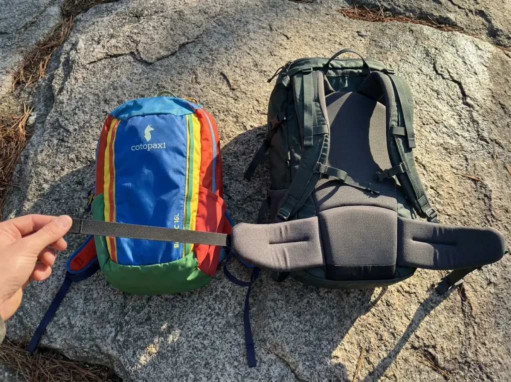 Budget 16-liter daypack next to a premium pack comparing hipbelt and straps