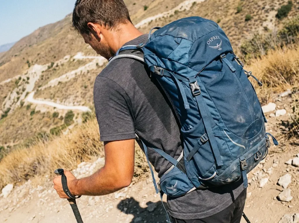 Sweat-soaked hiker's back showing the suspended-mesh panel gap on a hot climb