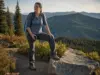 Best Women’s Hiking Shoes That Fit a Woman’s Foot Woman on a switchback in women's hiking shoes, dust on the leather uppers, ridgelines behind her