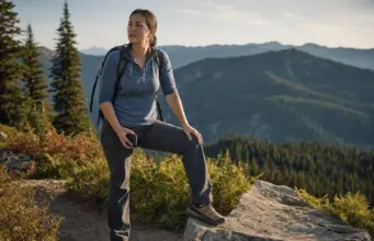 Best Women’s Hiking Shoes That Fit a Woman’s Foot Woman on a switchback in women's hiking shoes, dust on the leather uppers, ridgelines behind her