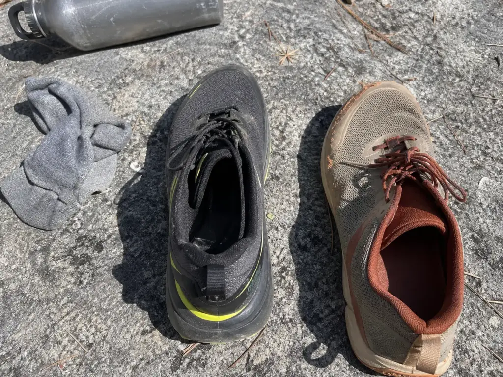 Two trail running shoes side by side showing the heel-to-toe drop difference between them