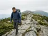 Best Hikes in New Hampshire by How Much Time You Have Hiker on the exposed Franconia Ridge trail in the White Mountains, New Hampshire, under flat overcast
