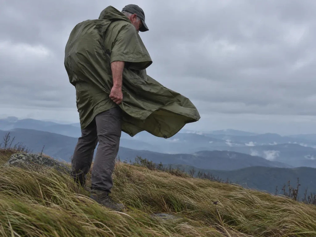 Wind lifting the loose hem of a hiking poncho on an exposed Blue Ridge ridgeline