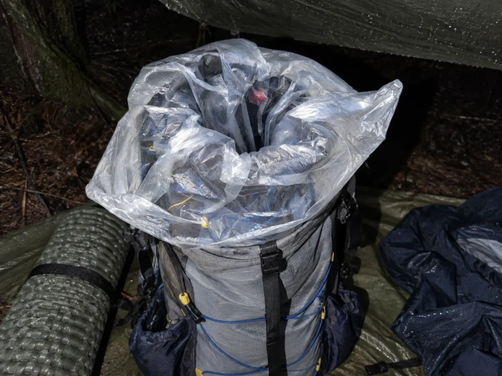 Pack liner bag rolled closed inside a backpack to keep gear dry in the rain