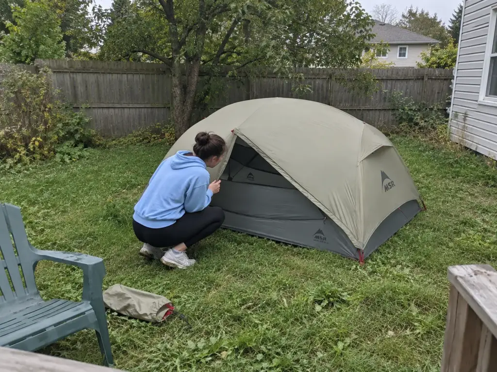 First backpacking tent, an MSR Hubba Hubba LT2, practice-pitched on a backyard lawn before a shakedown trip