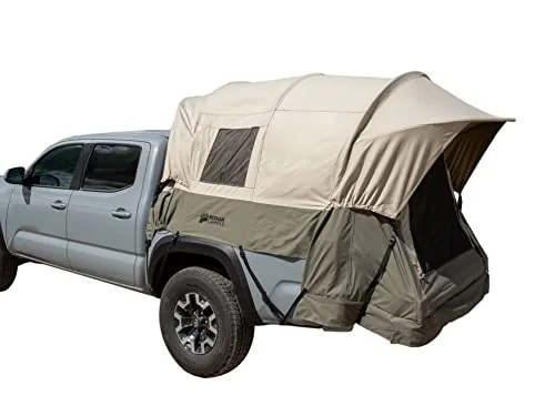 Kodiak Canvas truck tent in cotton duck canvas pitched in a mid-size pickup bed at a trailhead basecamp